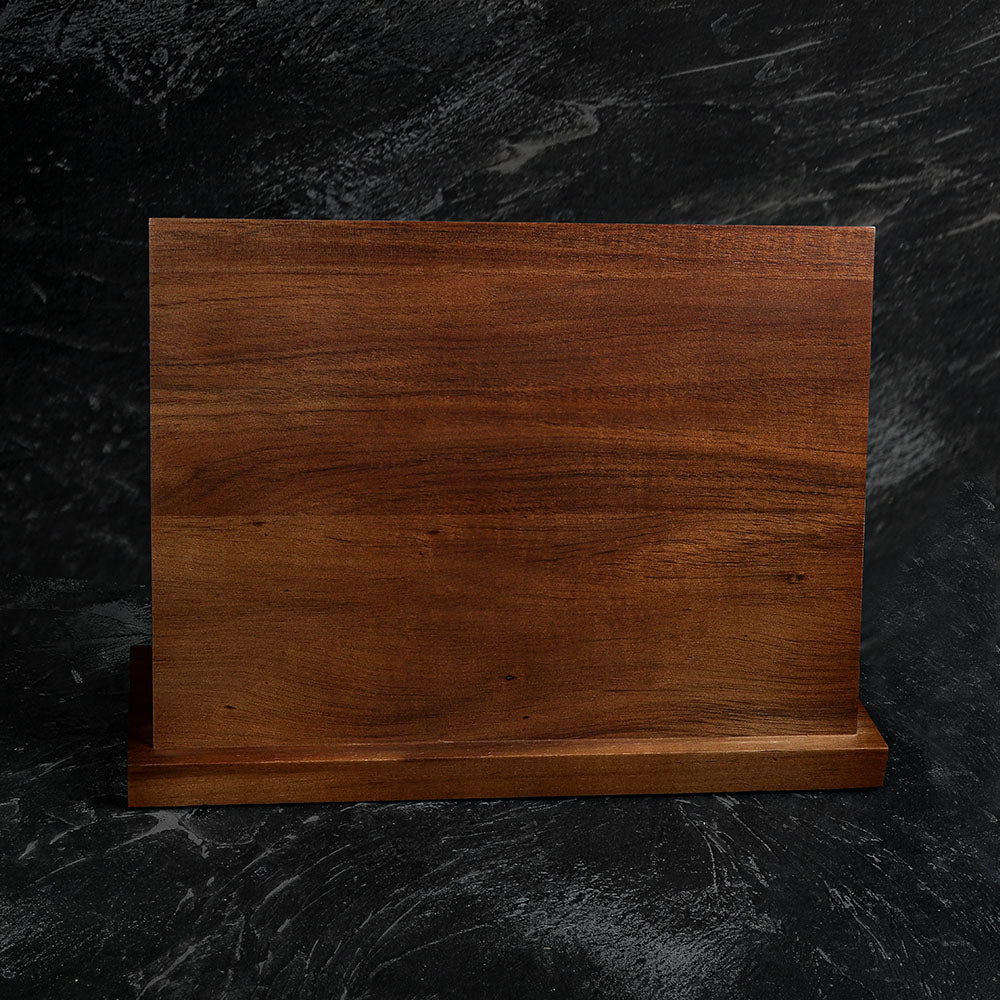 Wooden cutting board on a dark textured surface