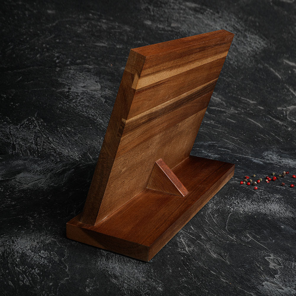 Wooden cutting board with a stand on a dark stone surface