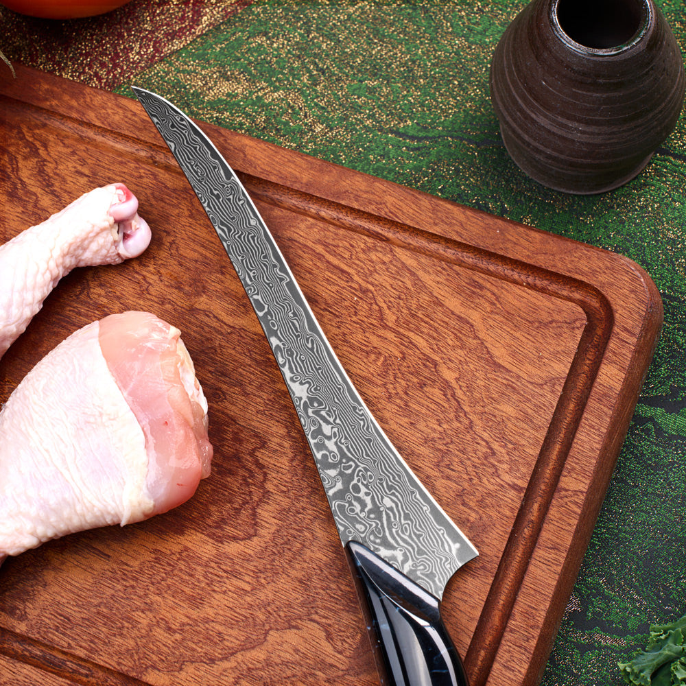 Damascus knife on a wooden cutting board with raw chicken pieces