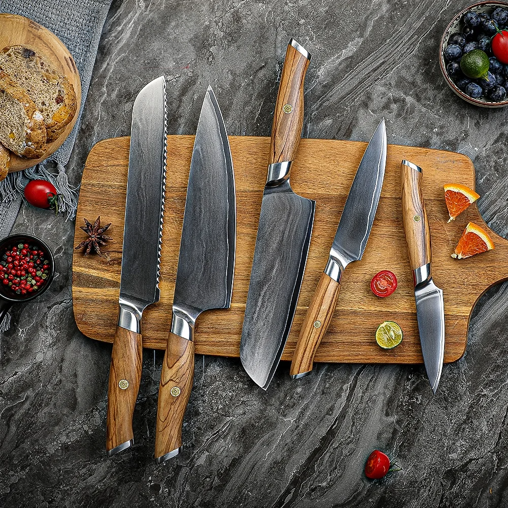 Set of 5 VG10 Knives with Olive Wood handle on a wooden cutting board