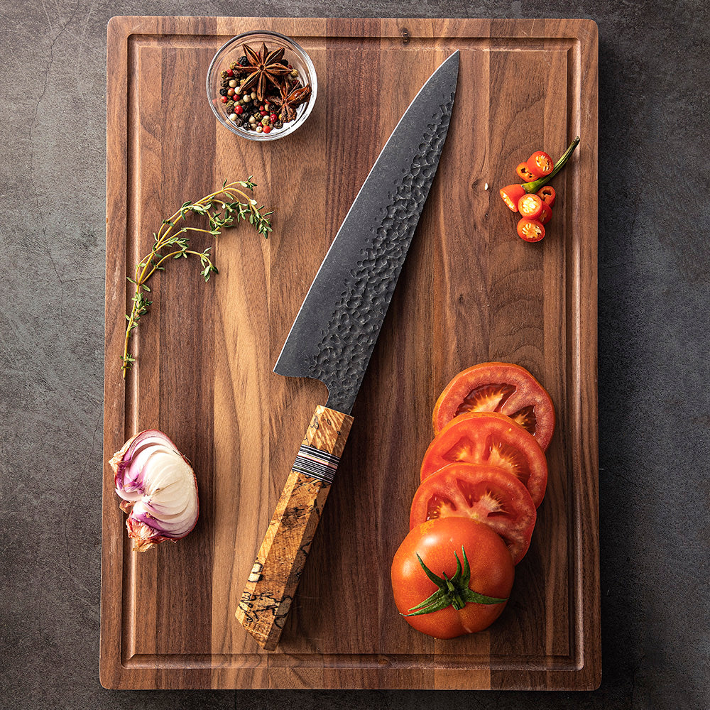 Carbon steel knife on wooden board tomatoes sliced