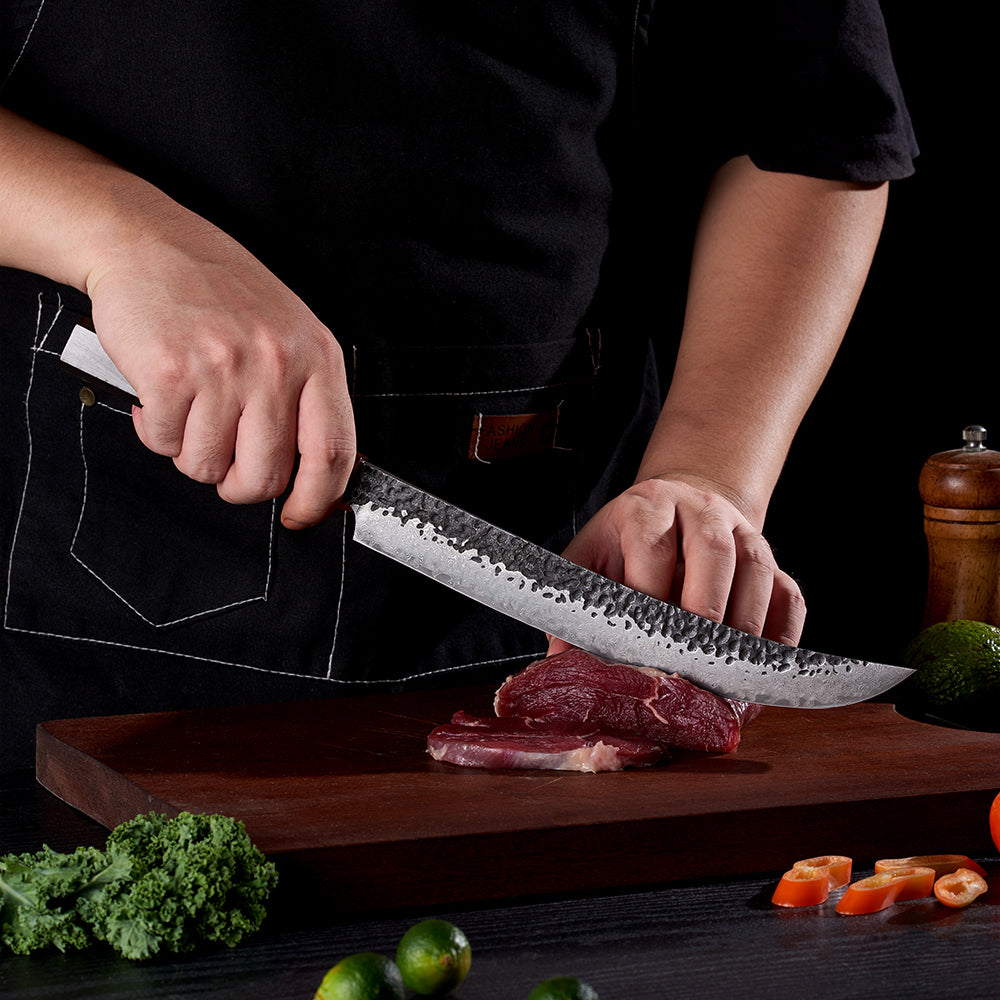 Japanese Chef cuts steak with sharp long damascus knife 